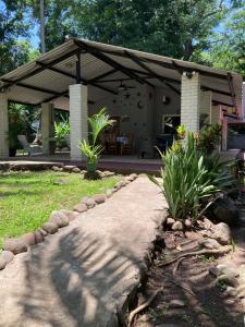 a stone path leading to a house with a pavilion at Beach House EL Cocalito in La Libertad