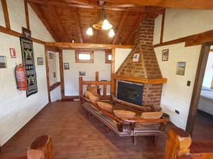 a living room with a fireplace in a house at Taytapak Wasi in Riobamba
