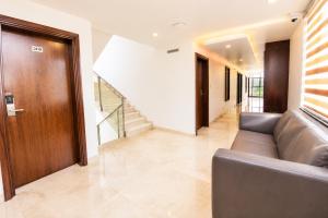 a living room with a couch and a staircase at Hotel Hotel HVH Elite Kashi Vishwanath # Resturent and Free Wifi in Varanasi