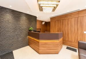 an office lobby with wooden walls and a reception desk at Hotel Hotel HVH Elite Kashi Vishwanath # Resturent and Free Wifi in Varanasi