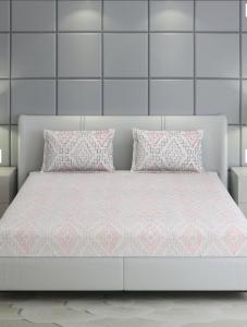 a white bed with two pillows on top of it at बिश्नोई भवन in New Delhi