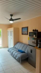 a bed in a room with a ceiling fan at Paradise Nest in Oranjestad