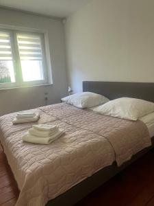 a bedroom with a bed with two towels on it at Historic Charm Apartment Bayreuth in Bayreuth