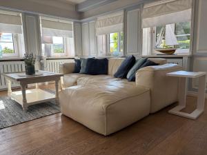 a living room with a couch and a table at Deichhof Whg Luana in Dunsum +19 photos