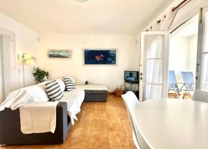 a living room with a couch and a table at White Sands 4.20 in Arenal d'en Castell