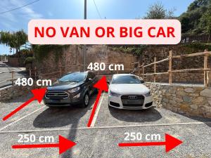 two cars are parked in a parking lot at Behind the Sea - Parcheggio gratis - mare 5 min in Noli