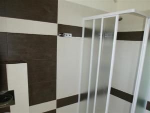a bathroom with a shower with a glass door at OW Viva in Jantar