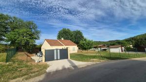 a house with a garage on the side of a road at Maison à Cahors in Cahors