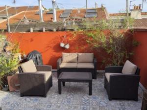 a patio with two chairs and a table and chairs at Loft in a quiet condominium in Vitry-sur-Seine