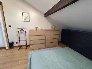a bedroom with a bed and a dresser and a ladder at Loft in a quiet condominium in Vitry-sur-Seine