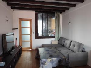 a living room with a couch and a table at Loft in a quiet condominium in Vitry-sur-Seine