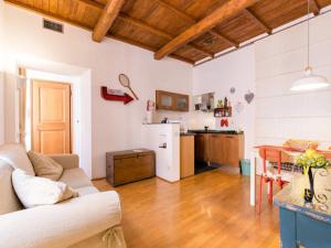 a living room with a couch and a kitchen at Il Mandorlo a Monti in Rome