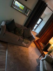 a living room with a couch and a window at The Loft in Nantgaredig