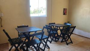 a group of tables and chairs in a room at Mini Suítes - Centro de Tutóia in Tutóia +26 photos