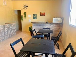 a restaurant with tables and chairs in a room at Mini Suítes - Centro de Tutóia in Tutóia