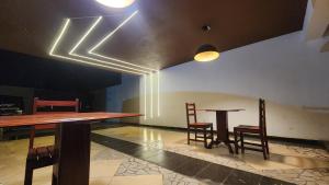 a dining room with two tables and two chairs at ORO - Boutique Guesthouse in Matola
