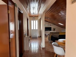 a hallway with a living room and a dining room at Tina's Place in Machico