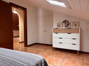 a bedroom with a bed and a dresser at Tina's Place in Machico