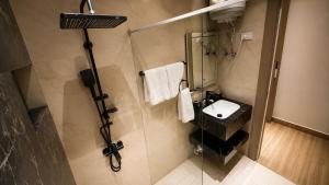 a bathroom with a sink and a shower at Sama Al Sweifieh - سما الصويفية in Amman