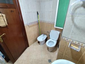 a bathroom with a toilet and a sink and a shower at La Luna Rentals in Asilah