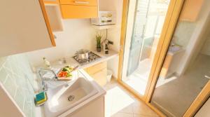 a small bathroom with a sink and a shower at The Sea Wind Apartments & Suites in Palau