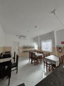 a dining room with tables and chairs in a restaurant at Pousada Bela Rainha in Aparecida +58 photos