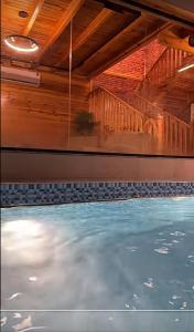 a indoor swimming pool with a ceiling and water at اكواخ لاكجري ابها 2 in Abha