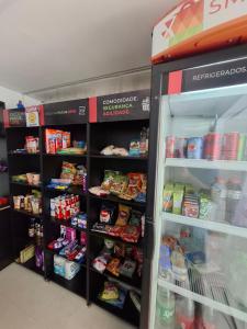 a refrigerator in a store filled with lots of food at Estudio232 - Asa Sul in Brasília +6 photos