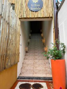 a stairway leading up to a building with a sign at Trindade - Suíte Mandala in Trindade