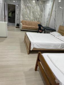 a room with two beds and a couch at Blue Horizon in Grigoleti