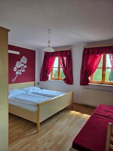 a bedroom with a bed and two windows at Reitpark Gstöttner in Schönau im Mühlkreis