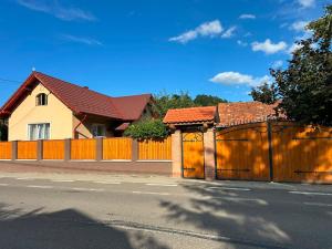 a wooden fence in front of a house at La Nea Traian in Vama Buzăului