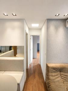 a room with two beds and a hallway at Apt Premium com Vista Panorâmica e Lazer Completo in Joinville