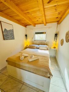 a bedroom with a large bed with towels on it at Villa Silent Bay Lučice in Milna +10 photos