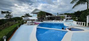 a swimming pool in front of a house at Barracuda apartments in Sámara