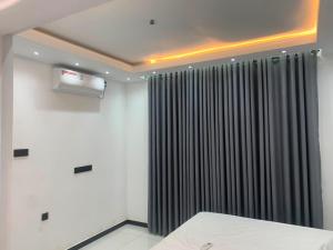 a room with a bed and a black curtain at Elysian Ridge Villa in Welimada