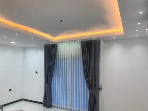 a room with a ceiling with a window and curtains at Elysian Ridge Villa in Welimada