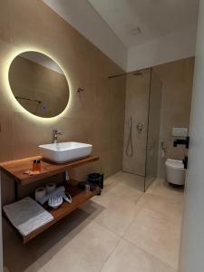 a bathroom with a sink and a shower at RiverMount Hotel Borsh in Borsh +28 photos