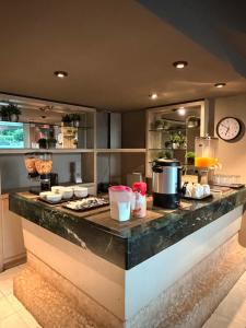 a kitchen with a counter with a counter top at Plaza Inn Express in Tapachula