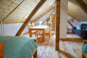 a room with a table and a dining room at Lawki Booking-Na Strychu in Ławki