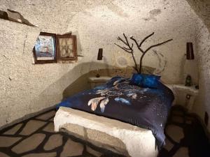 a bedroom with a bed with a tree on it at Casas Cueva Alfer in Fasnia +48 photos