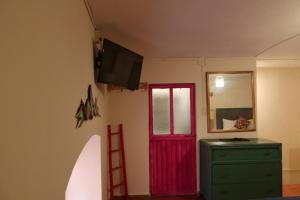 a room with a red door and a red ladder at Rinconcito de Galarza 28 in Guanajuato