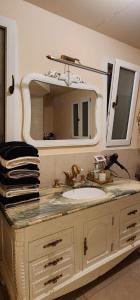 a bathroom with a sink and a mirror at Golden House גולדן האוז in Kidmat Tsvi +16 photos