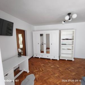 a white room with a desk and a tv at Apartament -BeaSarah-Orsova in Orşova