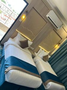 a large bed in a room with a window at The High View Hotel - ذا هاي فيو in Al Baha