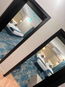 a window in a room with two beds at The High View Hotel - ذا هاي فيو in Al Baha