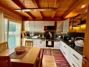 a kitchen with a wooden ceiling and a table at Villa Kadeli 