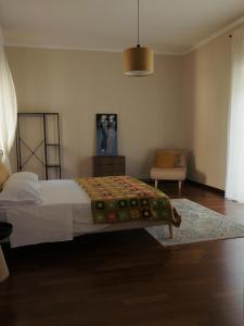 a bedroom with a bed and a chair at Domus Flumen in Alife