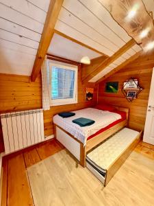 a bedroom with a bed in a wooden cabin at Villa Kadeli 