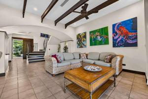 a living room with a couch and a table at Resort Villa Pool Golf & Beach Access in Playa Avellana
